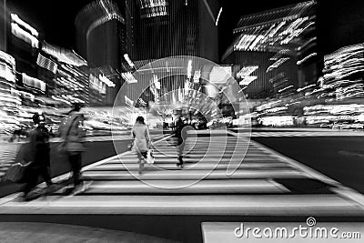 Pedestrians crossing the street at the heart of Ginza District in Tokyo. Ginza crossing at night. Blurred motion Editorial Stock Photo