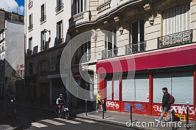 Pedestrians walking down Parisian streets in 10th arrondissement Editorial Stock Photo