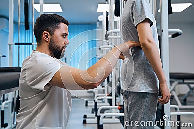 Pediatric chiropractor examines girls posture in closeup side view. Physical therapist checks spine Stock Photo