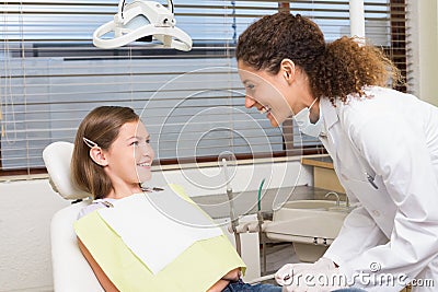 Pediatric dentist examining little girls teeth in the dentists chair Stock Photo