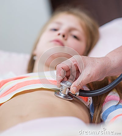 Pediatric doctor exams teen girl with stethoscope Stock Photo