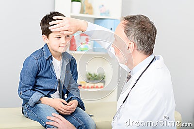 Pediatrician checking temperature of sick patient Stock Photo
