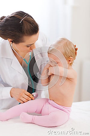 Pediatrician doctor calming crying baby Stock Photo