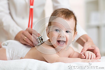 Pediatrician doctor examines baby with stethoscope Stock Photo