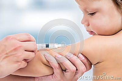 Pediatrician doctor vaccinating baby Stock Photo