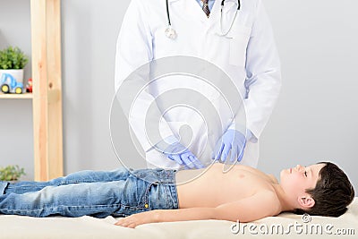 Pediatrician doing checkup on young boy Stock Photo