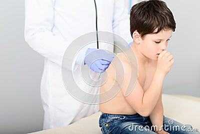 Pediatrician doing checkup on young boy Stock Photo