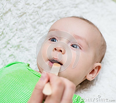 Pediatrician examines a newborn baby with a spatula Stock Photo