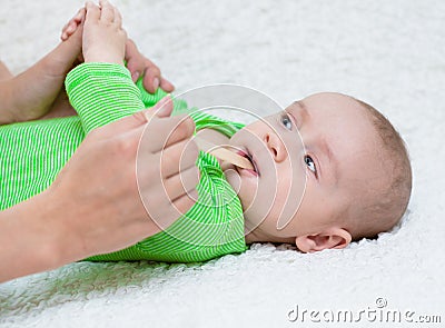 Pediatrician examines a newborn baby with a spatula Stock Photo