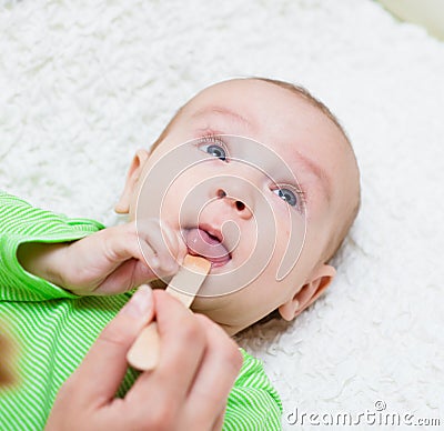 Pediatrician examines a newborn baby with a spatula Stock Photo