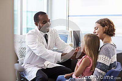 Pediatrician Examining Child In Hospital Stock Photo