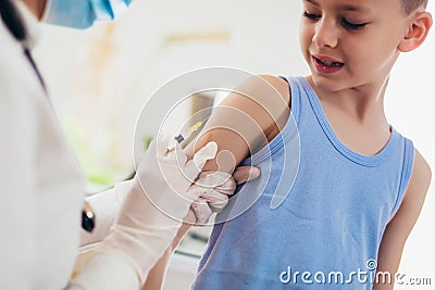 Pediatrician makes vaccination to small boy. Stock Photo