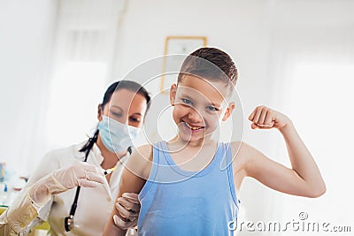 Pediatrician makes vaccination to small boy. Stock Photo