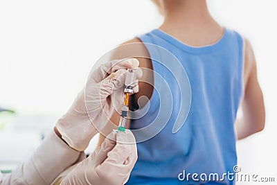 Pediatrician makes vaccination to small boy. Stock Photo