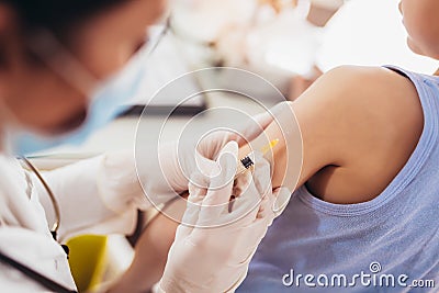 Pediatrician makes vaccination to small boy. Stock Photo