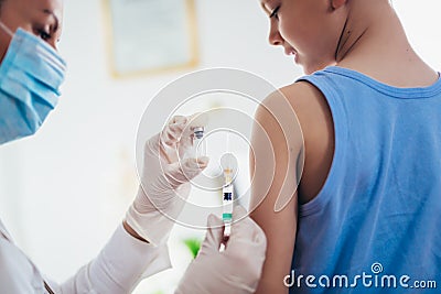 Pediatrician makes vaccination to small boy. Stock Photo