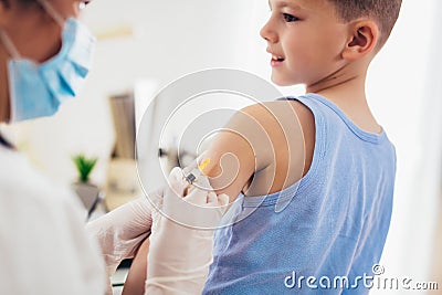 Pediatrician makes vaccination to small boy. Stock Photo