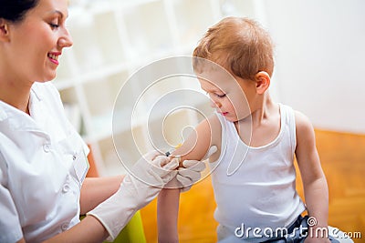 Pediatrician makes vaccination toboy Stock Photo