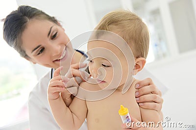 Pediatrician taking baby's temperature Stock Photo