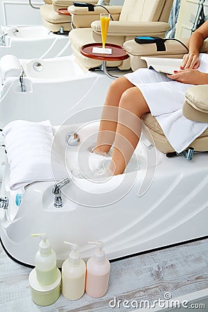 Pedicure feet bath in sofa chair at nails salon Stock Photo