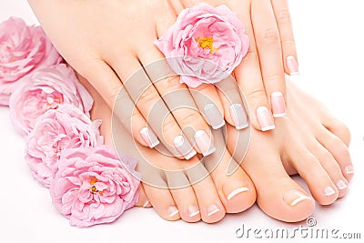 Pedicure and manicure with a pink rose flower Stock Photo