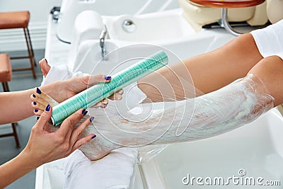 Pedicure nourishing mask legs cling film wrap Stock Photo