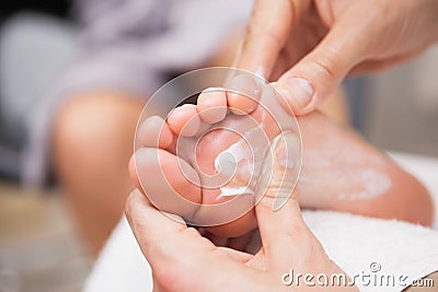Pedicurist massaging a customers foot Stock Photo