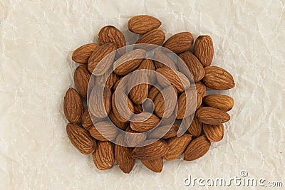 Peeled almond nuts isolated on parchment paper Stock Photo
