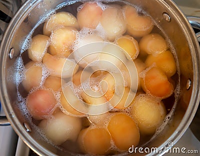 Peeled boiled apples in a sugar syrup Stock Photo