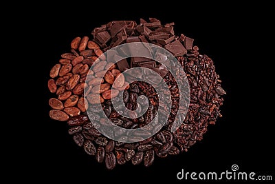 Peeled, chopped cocoa beans and pile chopped, milled chocolate isolated on black background Stock Photo