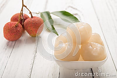 Peeled lichee in front with some fresh unpeel ones on background Stock Photo