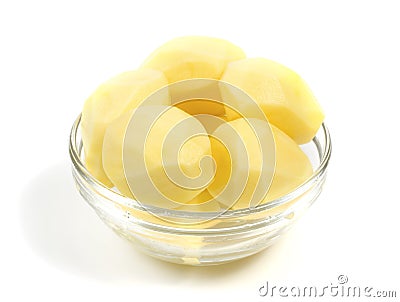 Peeled potatoes in a glass bowl Stock Photo