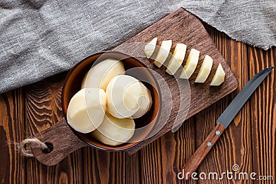 Peeled sliced potatoes on a cutting board Stock Photo