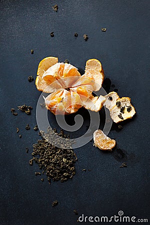 Peeled tangerine lies on the board. There are drops of juice around. Stock Photo