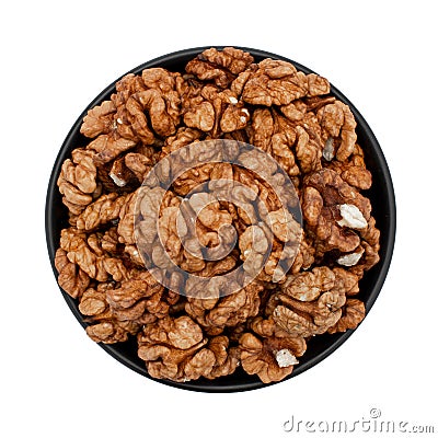 Peeled walnuts in a bowl isolated on white, top view. Stock Photo