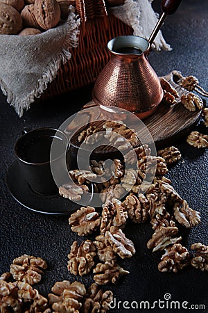 Peeled walnuts on a dark background. Coffee in a copper turk. Kernel of a walnut. Natural product. Vertical photo Stock Photo
