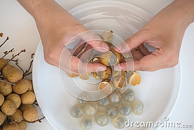 Peeling longan fruits Stock Photo