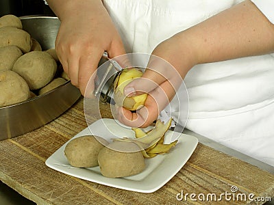 Peeling potatoes Stock Photo