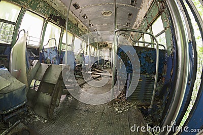 Peeling seats and debris inside abandoned trolley car Stock Photo