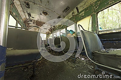 Peeling seats inside abandoned trolley car Stock Photo