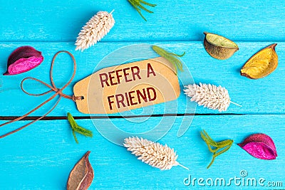 refer a friend text on paper tag Stock Photo