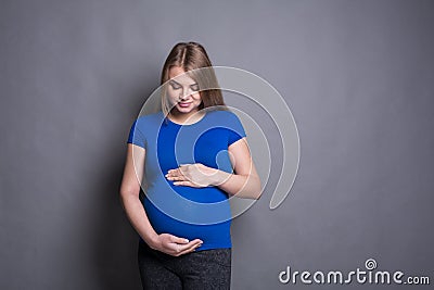 Pegnant woman caressing her belly Stock Photo