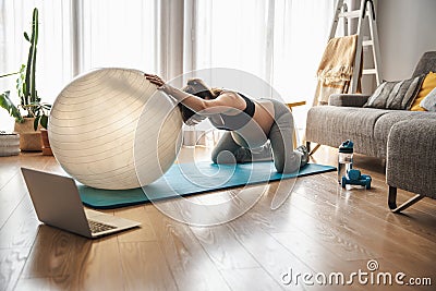 Pegnant woman doing exercise at home Stock Photo