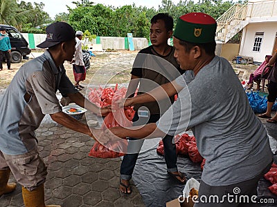 Pekanbaru - July 10, 2022 : distribution of sacrificial meat for Muslims Editorial Stock Photo