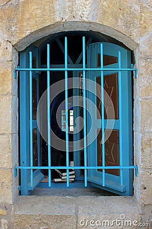 Open window of a synagogue with blue shutters Peki`in, a Druze village in the northern district of Israel. Stock Photo