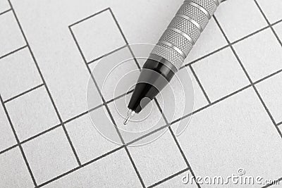 Pen on blank crossword, top view. Intellectual entertainment Stock Photo
