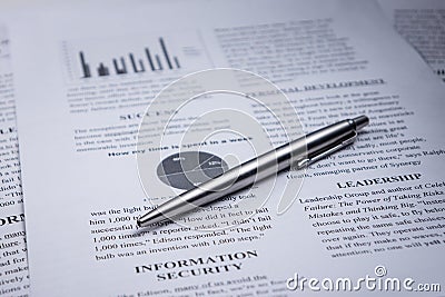 A pen on business text and word leadership and information security Stock Photo