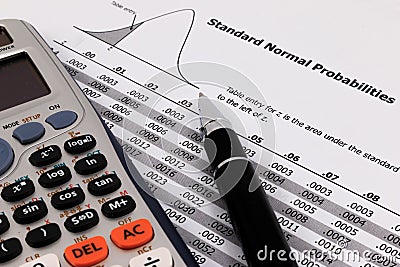 Pen and calculator on standard normal probabilities table. Stock Photo