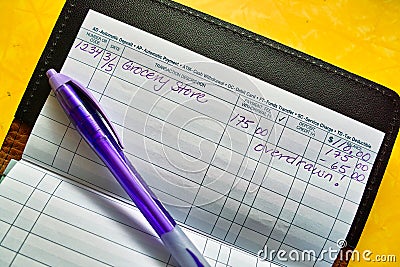 Pen and checkbook register Stock Photo