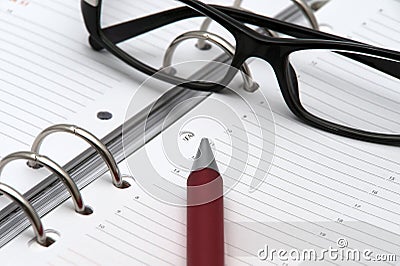 Pen and glasses on calendar event Stock Photo